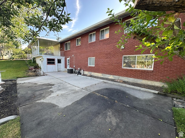 487 Highland Blvd, Brigham City, UT 84302 - view of home's exterior with a patio, brick siding, and a lawn