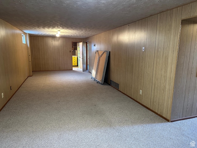 487 Highland Blvd, Brigham City, UT 84302 - spare room featuring light carpet, wood walls, and a textured ceiling