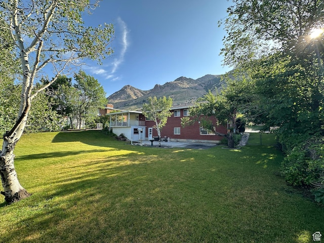 487 Highland Blvd, Brigham City, UT 84302 - view of grassy yard with a mountain view and a patio area