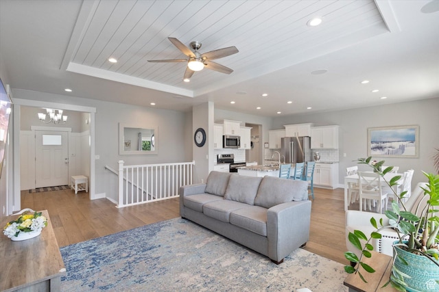 605 W 1660 S, Provo, UT 84601 - living area featuring a raised ceiling, light wood-type flooring, a ceiling fan, recessed lighting, and a chandelier