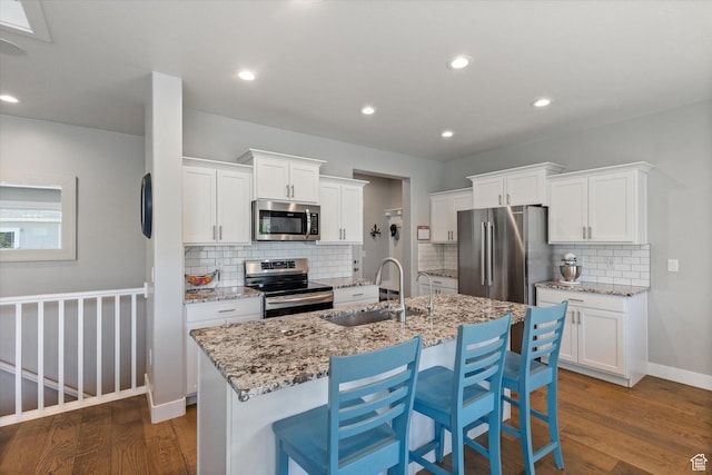 605 W 1660 S, Provo, UT 84601 - kitchen featuring appliances with stainless steel finishes, dark wood-style floors, decorative backsplash, white cabinetry, and recessed lighting