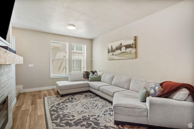 1017 S 2740 E, Spanish Fork, UT 84660 - living area featuring a brick fireplace, wood finished floors, and a textured ceiling