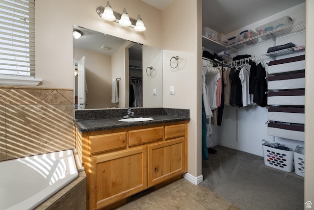 4145 W 700 N, Vernal, UT 84078 - full bath featuring vanity, a walk in closet, tile patterned flooring, and a tub