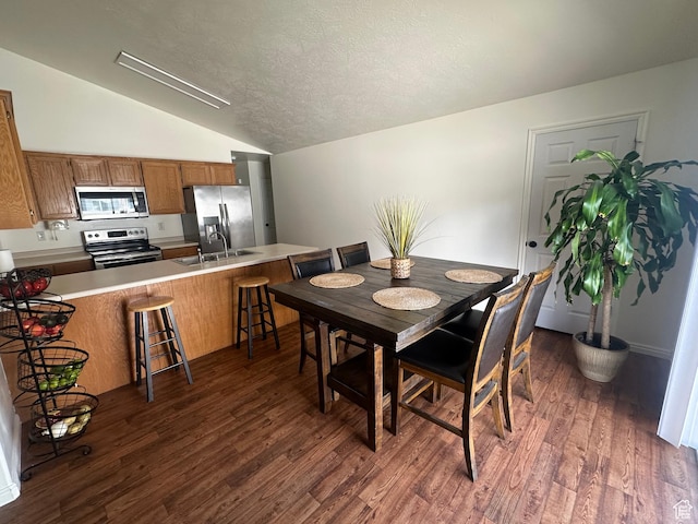 1485 N Monroe Blvd E, Ogden, UT 84404 - dining space with lofted ceiling, dark wood-style floors, and a textured ceiling