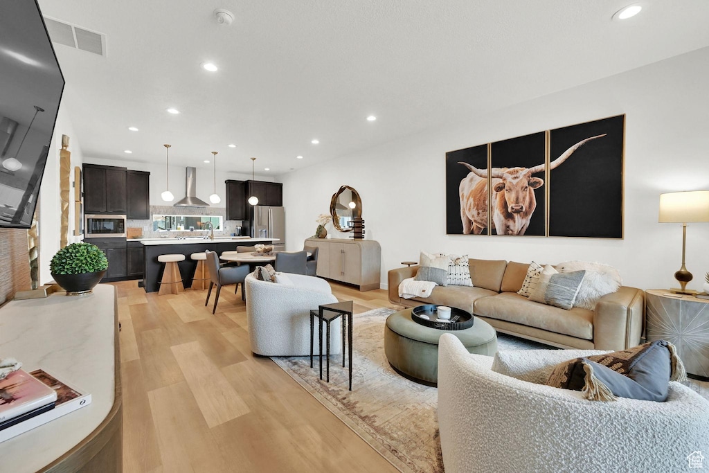 5970 Mesa Arch Ln Unit 222, Mountain Green, UT 84050 - living area featuring light wood-style floors and recessed lighting