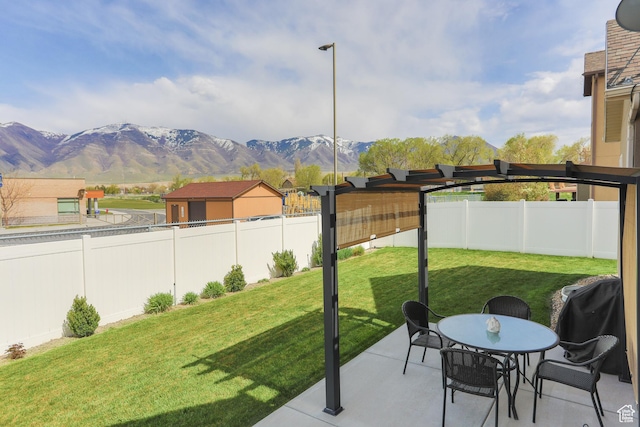 6628 N Malachite Way, Stansbury Park, UT 84074 - fenced backyard featuring a mountain view and a patio area