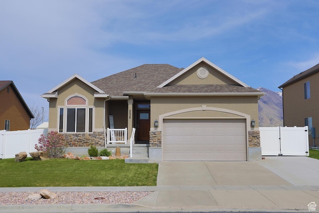 6628 N Malachite Way, Stansbury Park, UT 84074 - view of front of property with stone siding, stucco siding, concrete driveway, and a garage