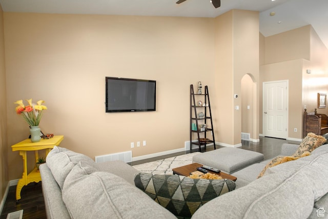 6628 N Malachite Way, Stansbury Park, UT 84074 - living room with arched walkways, ceiling fan, a high ceiling, and wood finished floors