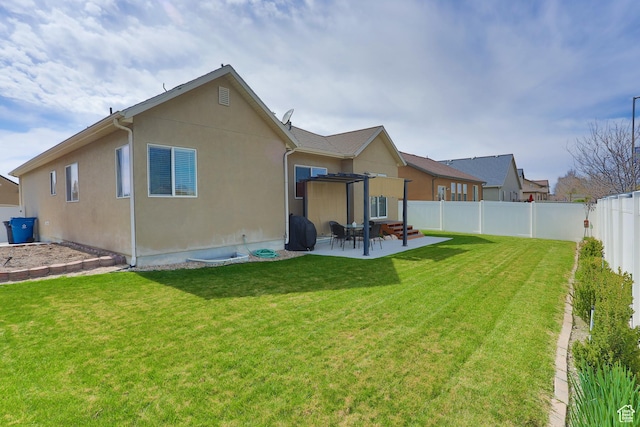 6628 N Malachite Way, Stansbury Park, UT 84074 - back of house with a fenced backyard, a patio, and stucco siding