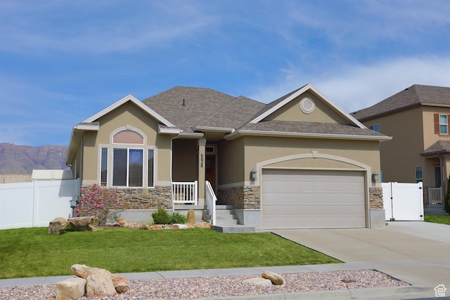 6628 N Malachite Way, Stansbury Park, UT 84074 - view of front of home with stucco siding, stone siding, driveway, a garage, and roof with shingles