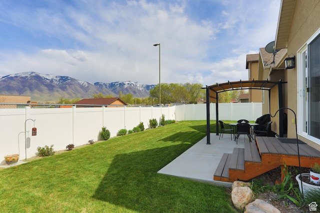 6628 N Malachite Way, Stansbury Park, UT 84074 - fenced backyard with a pergola, a mountain view, and a patio