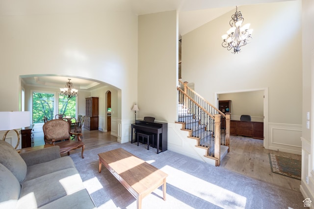 357 N Main St, Alpine, UT 84004 - living room with a chandelier, arched walkways, a towering ceiling, a decorative wall, and stairway