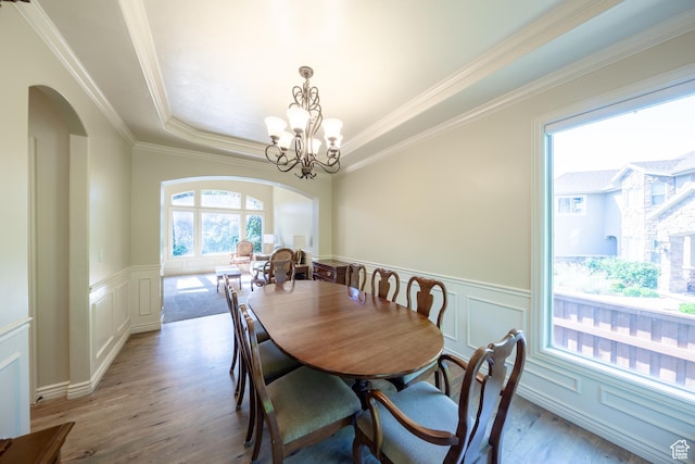 357 N Main St, Alpine, UT 84004 - dining area featuring arched walkways, light wood finished floors, a decorative wall, crown molding, and a wainscoted wall