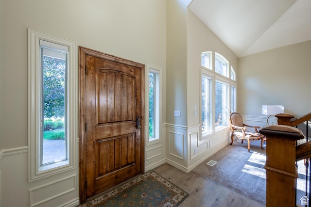357 N Main St, Alpine, UT 84004 - foyer featuring wood finished floors, a decorative wall, a wainscoted wall, and vaulted ceiling