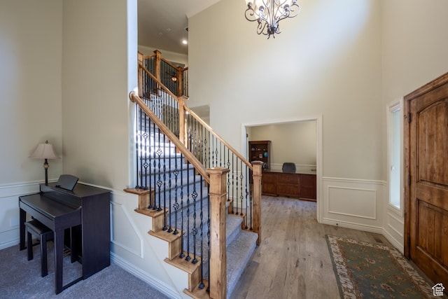 357 N Main St, Alpine, UT 84004 - entryway with a decorative wall, stairway, a wainscoted wall, wood finished floors, and a chandelier