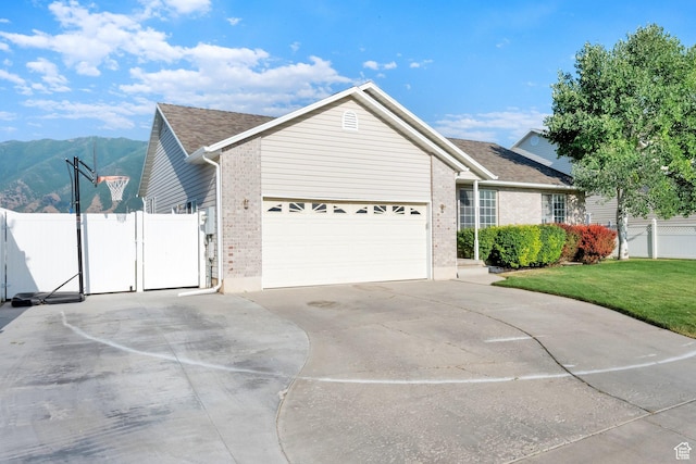 563 S 1850 E, Spanish Fork, UT 84660 - ranch-style home with brick siding, driveway, a garage, a mountain view, and a gate