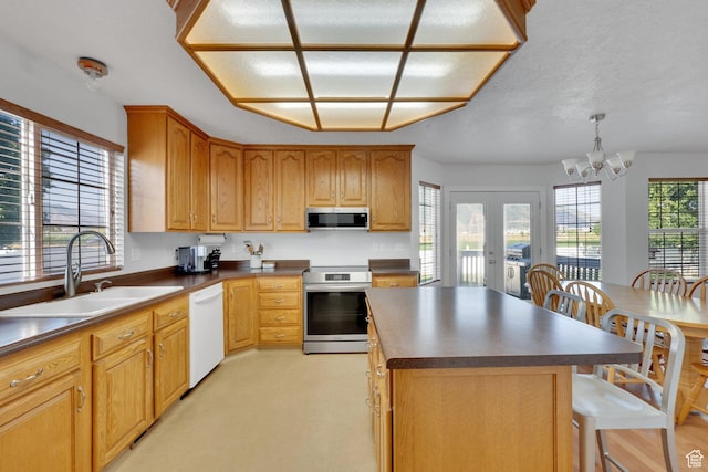 563 S 1850 E, Spanish Fork, UT 84660 - kitchen featuring appliances with stainless steel finishes, dark countertops, a center island, a kitchen breakfast bar, and french doors