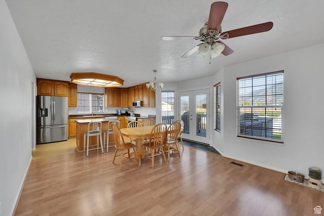 563 S 1850 E, Spanish Fork, UT 84660 - dining space with light wood finished floors, a ceiling fan, and a chandelier