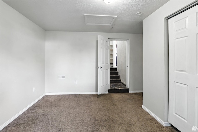 868 16th St, Ogden, UT 84404 - empty room with dark colored carpet, attic access, and a textured ceiling