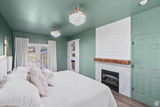 1292 E 810 S, Alpine, UT 84004 - bedroom featuring wood finished floors, a premium fireplace, french doors, access to exterior, and a chandelier