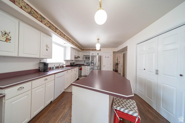 190 E 600 N, Ferron, UT 84523 - kitchen featuring stainless steel appliances, dark countertops, a kitchen island, and dark wood-style floors