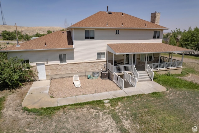 190 E 600 N, Ferron, UT 84523 - rear view of house with brick siding, a chimney, a porch, and a shingled roof