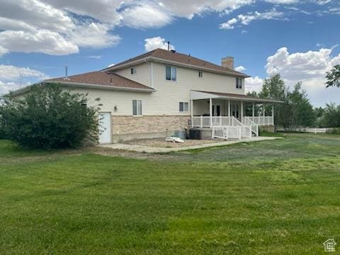 190 E 600 N, Ferron, UT 84523 - back of house featuring a lawn, a chimney, covered porch, and stone siding