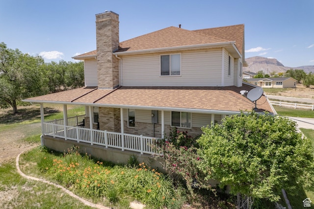 190 E 600 N, Ferron, UT 84523 - rear view of property featuring a chimney, roof with shingles, covered porch, and a mountain view