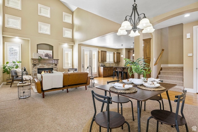 1362 E Shays Grove, Murray, UT 84121 - dining space with a chandelier, a fireplace, stairway, and light wood-style flooring