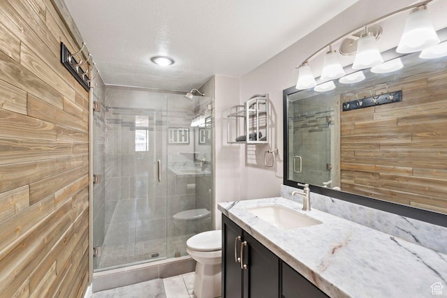 241 N Vine St Unit 506W, Salt Lake City, UT 84103 - bathroom featuring wooden walls, vanity, a shower stall, and a textured ceiling