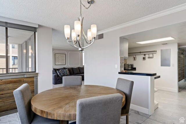 241 N Vine St Unit 506W, Salt Lake City, UT 84103 - dining space with a chandelier, ornamental molding, and a textured ceiling