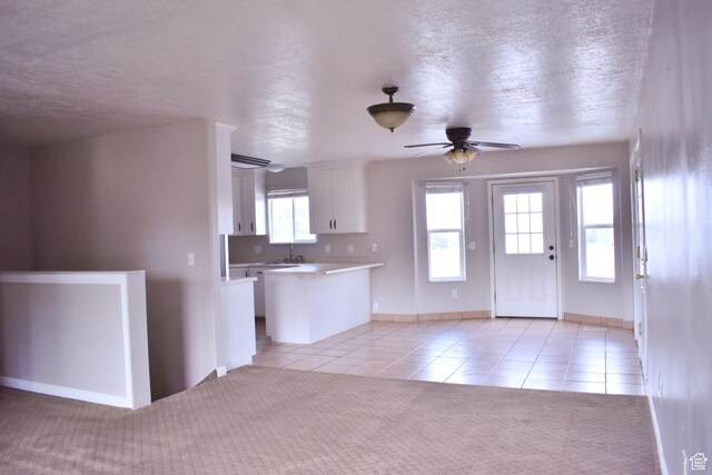 480 N 550 W, Huntington, UT 84528 - kitchen featuring light tile patterned floors, white cabinets, a ceiling fan, light countertops, and a textured ceiling