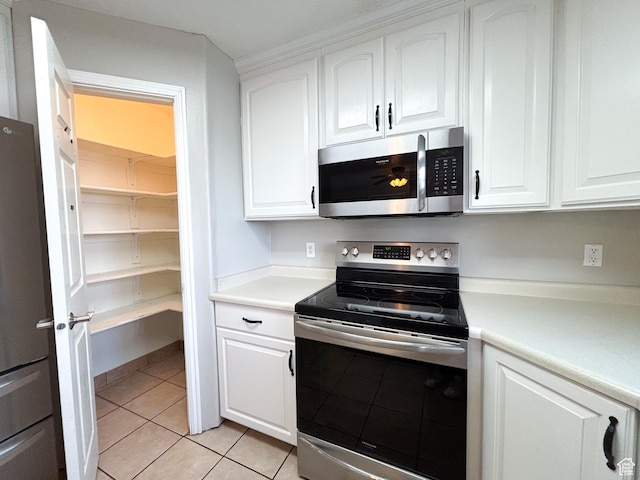 480 N 550 W, Huntington, UT 84528 - kitchen with appliances with stainless steel finishes, white cabinetry, light countertops, and light tile patterned floors
