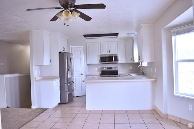 480 N 550 W, Huntington, UT 84528 - kitchen featuring stainless steel appliances, light tile patterned floors, white cabinets, light countertops, and a ceiling fan