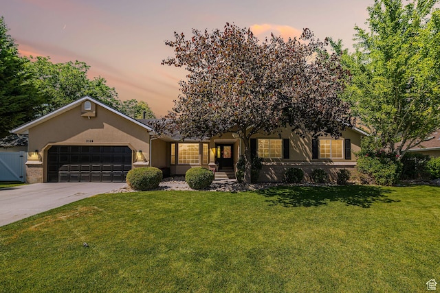 2524 W Martingale Cir S, South Jordan, UT 84095 - view of front of home featuring concrete driveway, a lawn, an attached garage, and stucco siding
