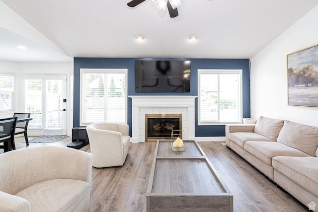 2524 W Martingale Cir S, South Jordan, UT 84095 - living room with wood finished floors, plenty of natural light, ceiling fan, a tiled fireplace, and lofted ceiling