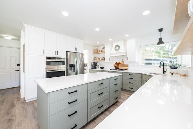2524 W Martingale Cir S, South Jordan, UT 84095 - kitchen with appliances with stainless steel finishes, gray cabinetry, premium range hood, light wood-style flooring, and recessed lighting