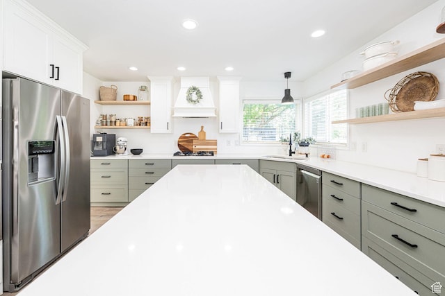 2524 W Martingale Cir S, South Jordan, UT 84095 - kitchen with stainless steel appliances, open shelves, custom range hood, light countertops, and white cabinetry