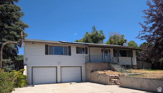 1455 S Hoytsville Rd, Coalville, UT 84017 - ranch-style house featuring driveway, an attached garage, roof mounted solar panels, a porch, and stairway