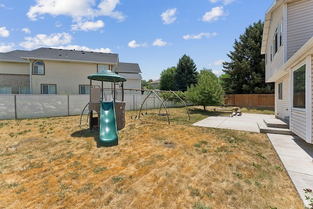 2198 N 1600 E, Layton, UT 84040 - fenced backyard featuring a playground and a patio area