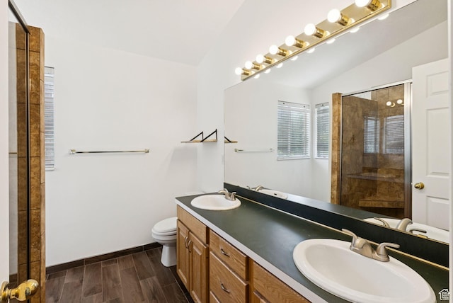 2198 N 1600 E, Layton, UT 84040 - bathroom featuring double vanity, wood finished floors, a tile shower, and lofted ceiling