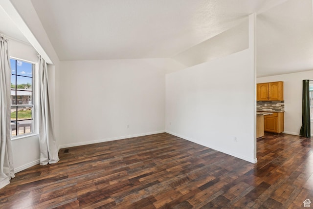 2198 N 1600 E, Layton, UT 84040 - unfurnished living room featuring vaulted ceiling and dark wood-style flooring