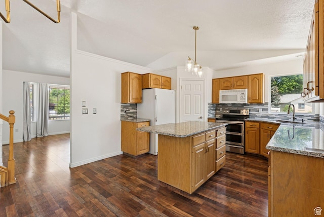 2198 N 1600 E, Layton, UT 84040 - kitchen with white appliances, lofted ceiling, a kitchen island, tasteful backsplash, and healthy amount of natural light