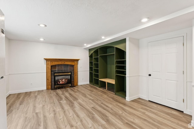 2198 N 1600 E, Layton, UT 84040 - unfurnished living room featuring wood finished floors, recessed lighting, and a tile fireplace