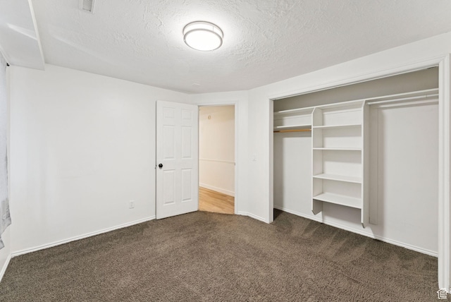 2198 N 1600 E, Layton, UT 84040 - unfurnished bedroom with dark carpet, a textured ceiling, and a closet