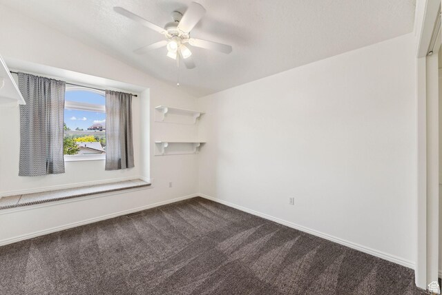 2198 N 1600 E, Layton, UT 84040 - spare room with dark colored carpet, a ceiling fan, and vaulted ceiling