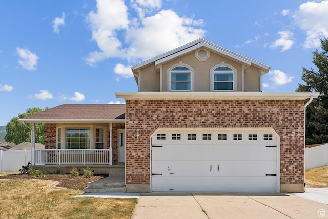 2198 N 1600 E, Layton, UT 84040 - view of front facade with brick siding, a porch, and driveway