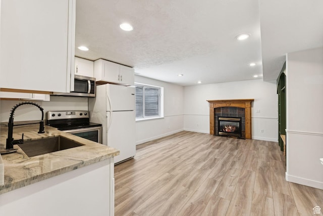 2198 N 1600 E, Layton, UT 84040 - kitchen with appliances with stainless steel finishes, light stone countertops, white cabinets, recessed lighting, and light wood finished floors