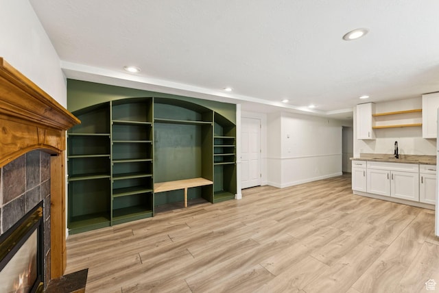 2198 N 1600 E, Layton, UT 84040 - unfurnished living room featuring a fireplace, light wood-style floors, recessed lighting, and bar area