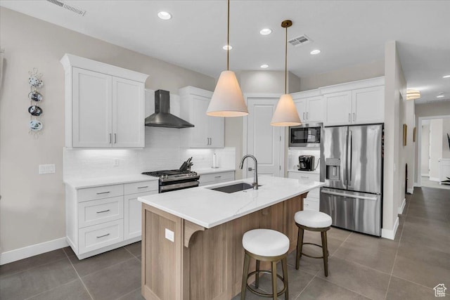 1219 W Ledgerwood Dr, St George, UT 84790 - kitchen with stainless steel appliances, wall chimney exhaust hood, decorative backsplash, dark tile patterned flooring, and white cabinetry